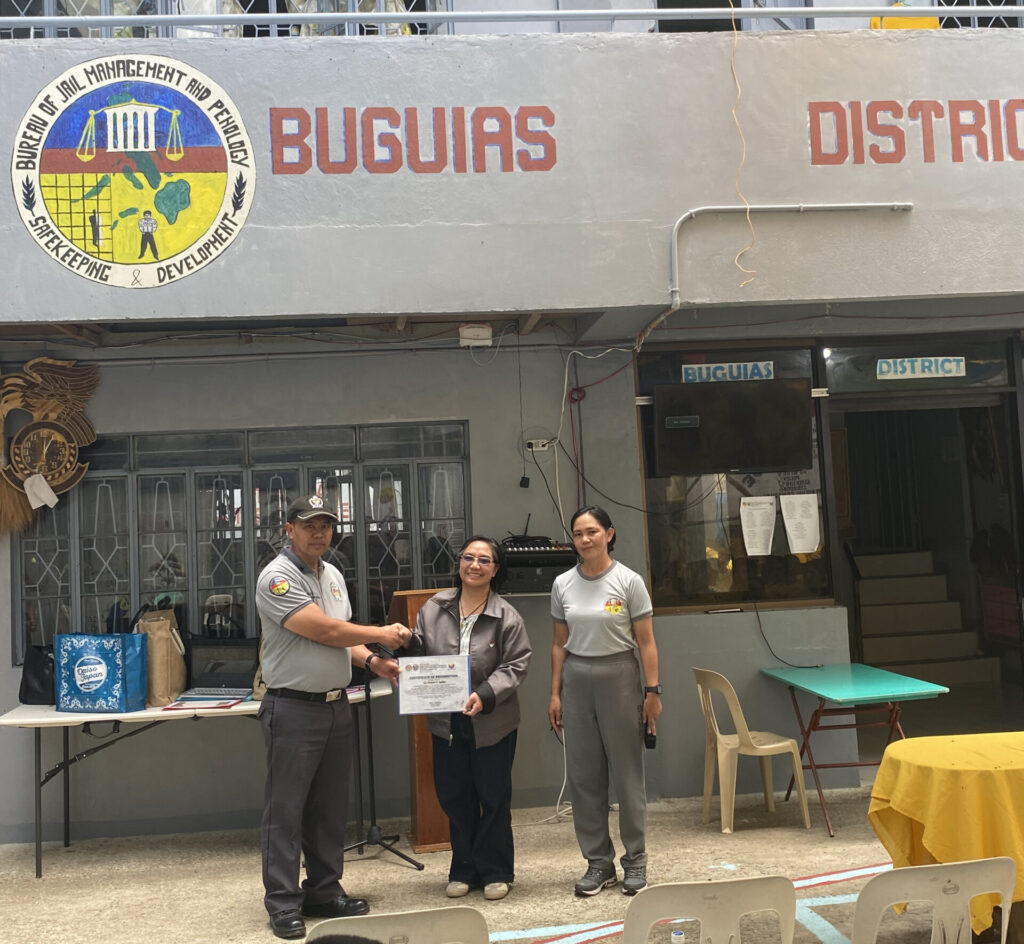 Dr. Violeta F. Apiles, UBHS Principal, receives a certificate of appreciation during the UBHS-BJMP Partnership visit to Buguias District Jail.