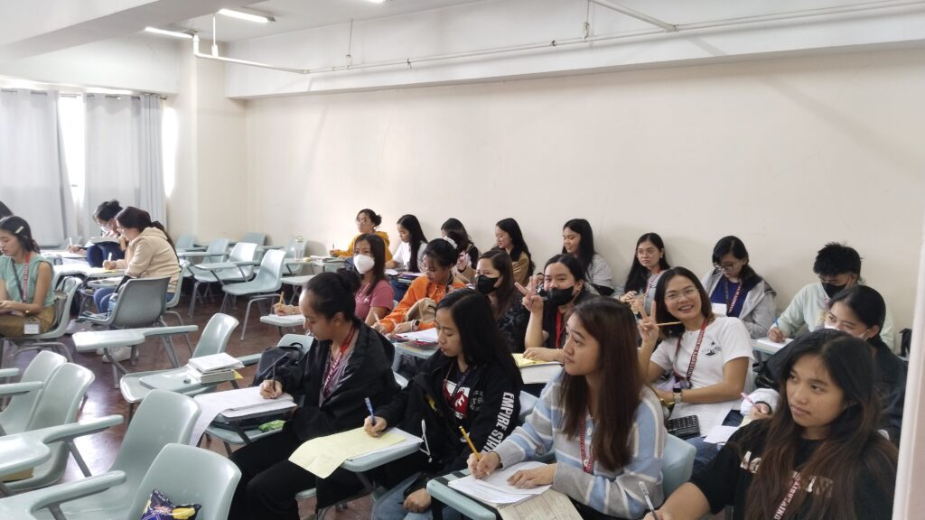 Accountancy students eager to learn, holding their pen, calculators and taking notes