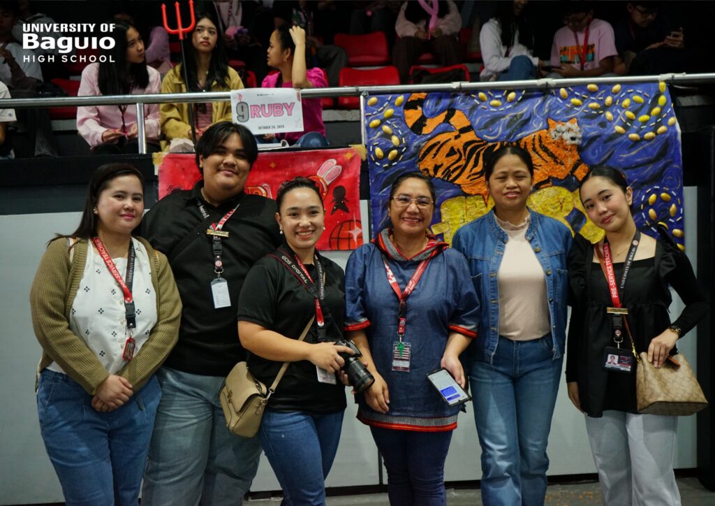 Student teachers and faculty members of the University of Baguio High School (UBHS) pose with colorful section banners displayed at the gym during the High School Day 2025 celebration, showcasing creativity, collaboration, and school pride.