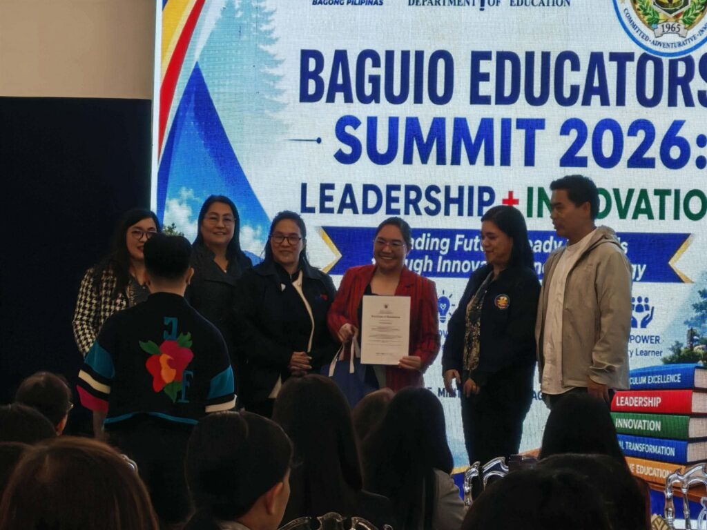 Dr. Violeta Apiles receiving a certificate for presenting the UBHS KALINGA learner care and learning continuity system.