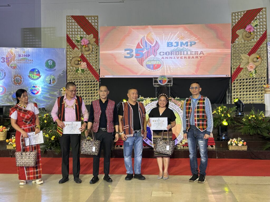 Dr. Violeta Apiles, UBHS Principal, receiving a Plaque of Recognition from BJMP-CAR